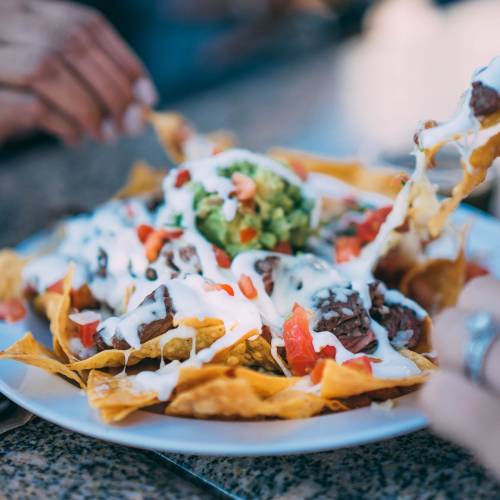 Veggie Stuffed Nachos with Cashew Queso and Green Sauce